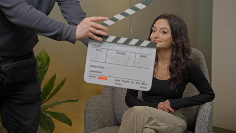 MHF Creative crew member holding a clapperboard