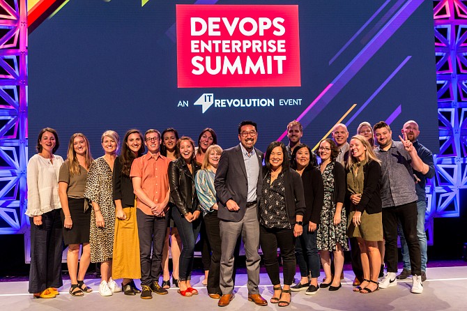 Corporate event photography featuring Devops team on stage