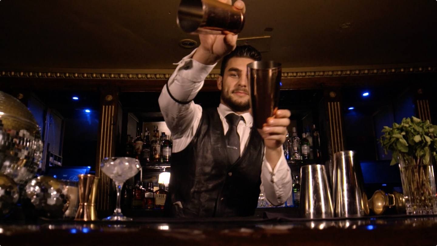 promotional video featuring bar man making a cocktail