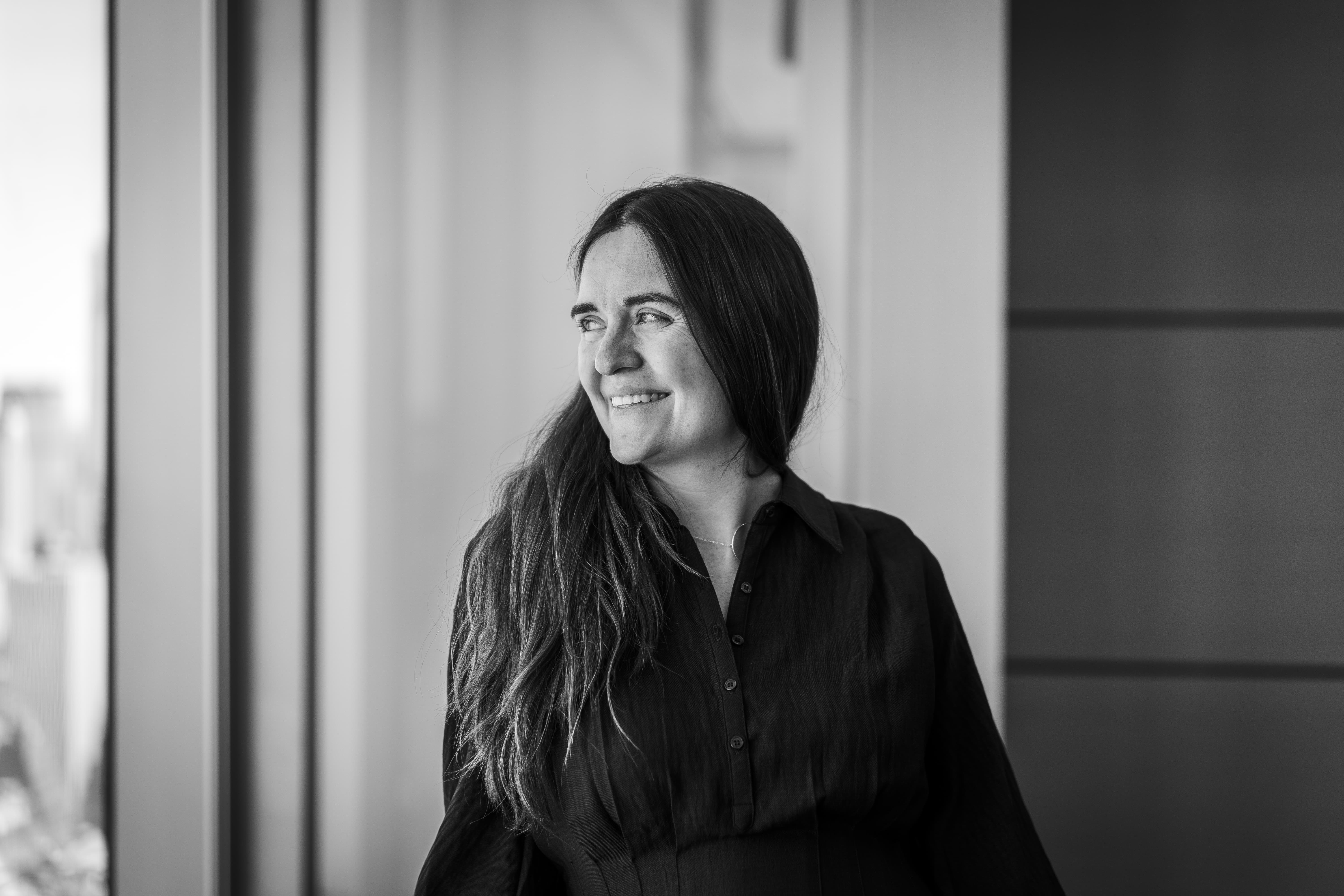 Black and white portrait of a senior female legal leader in an office setting