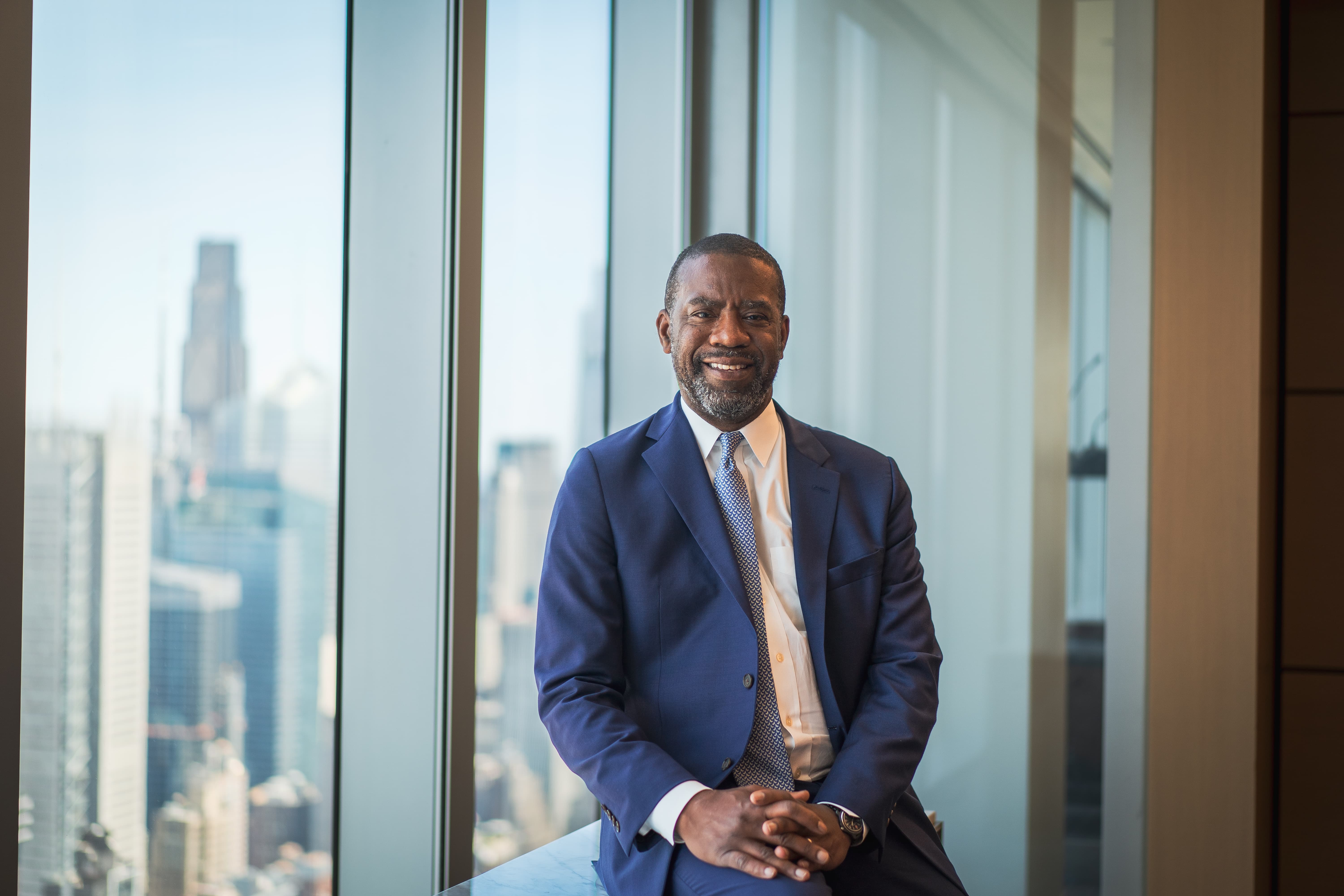 General Counsel seated by an office window for a corporate portrait in New York