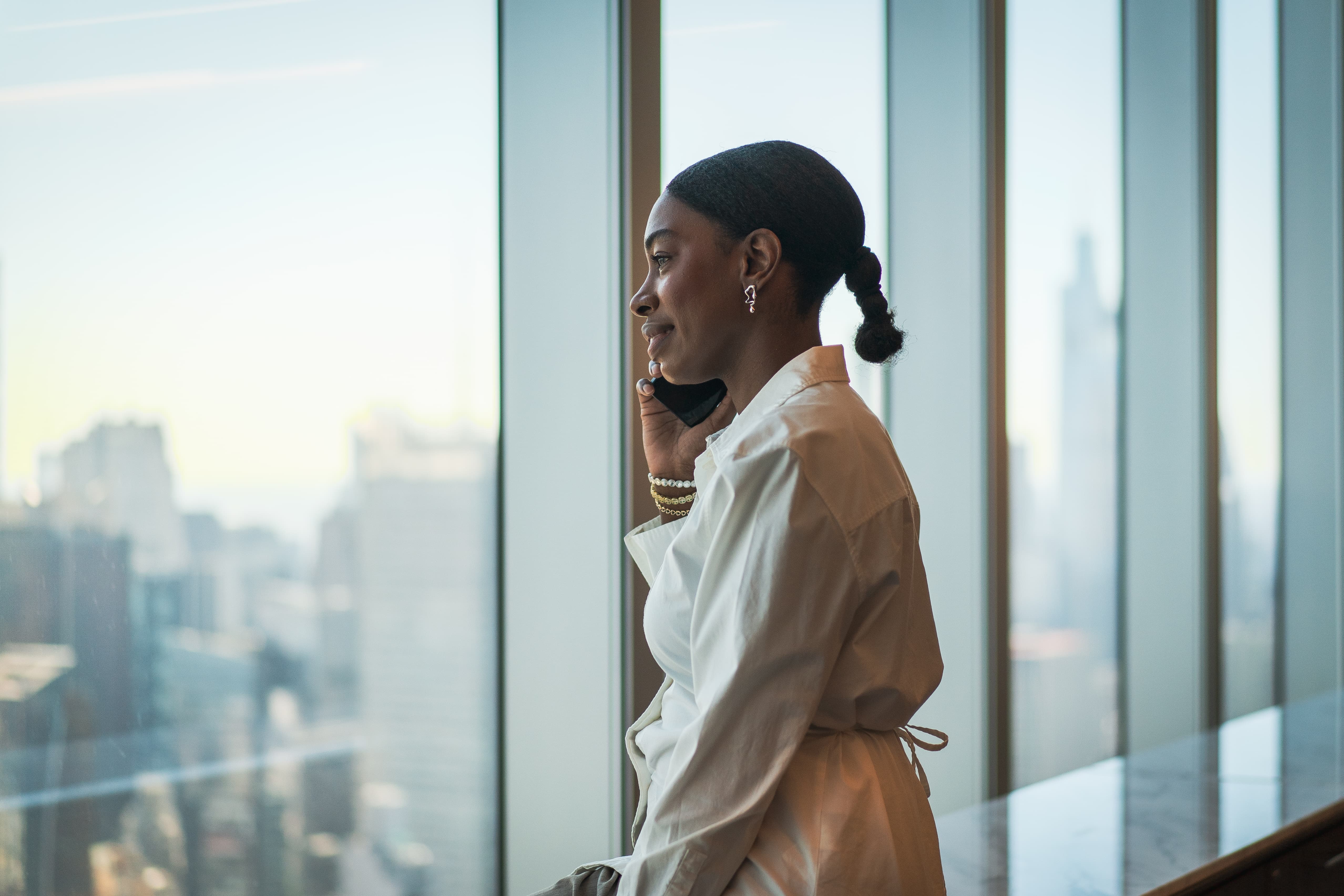 PERSUIT legal professional standing by an office window during a corporate photography shoot