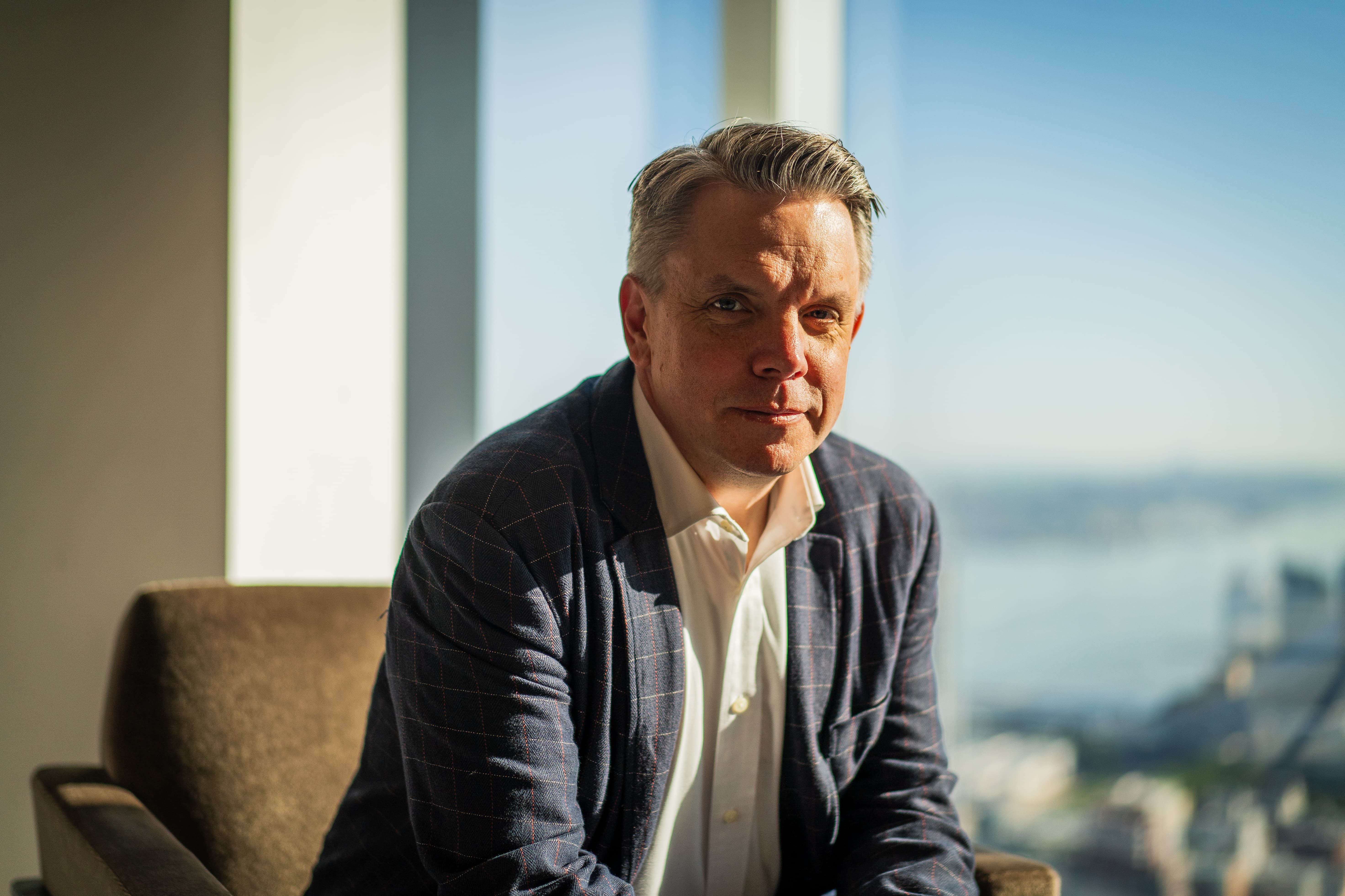 Senior legal leader photographed by a window during a PERSUIT corporate photography shoot