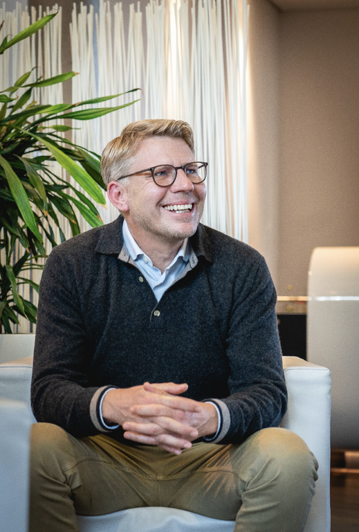 Senior legal leader seated for an executive corporate portrait