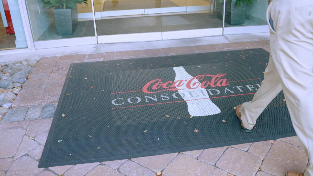 Man walking into coca cola offices
