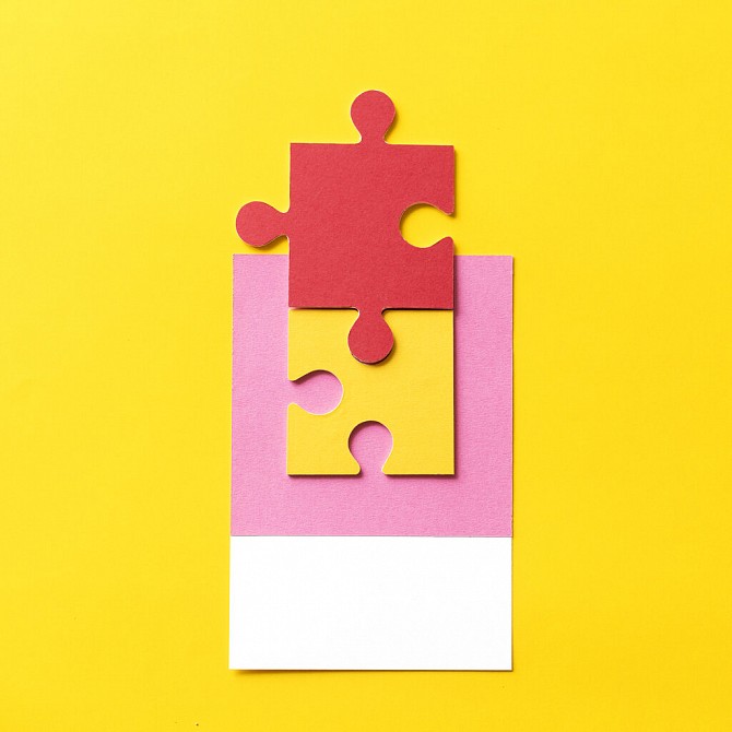 Puzzle pieces on yellow background