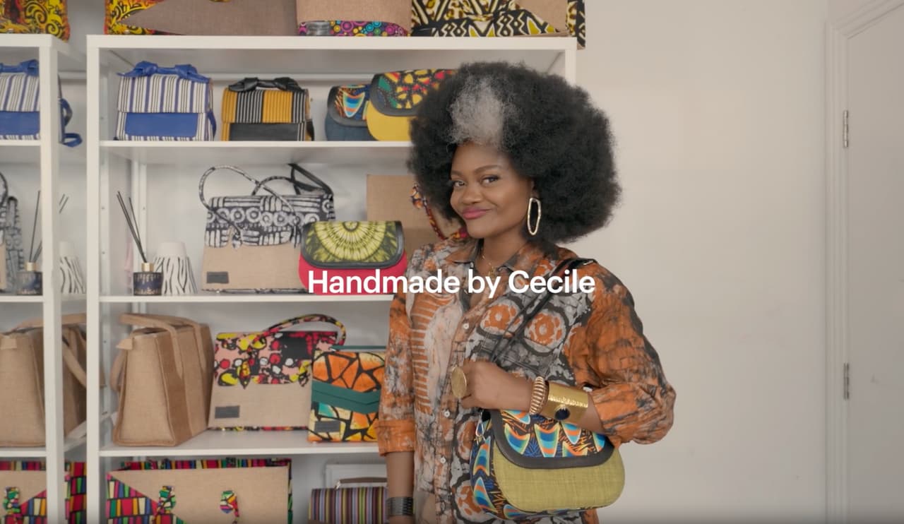 Independent Etsy seller holding one of her handmade bags in her creative studio