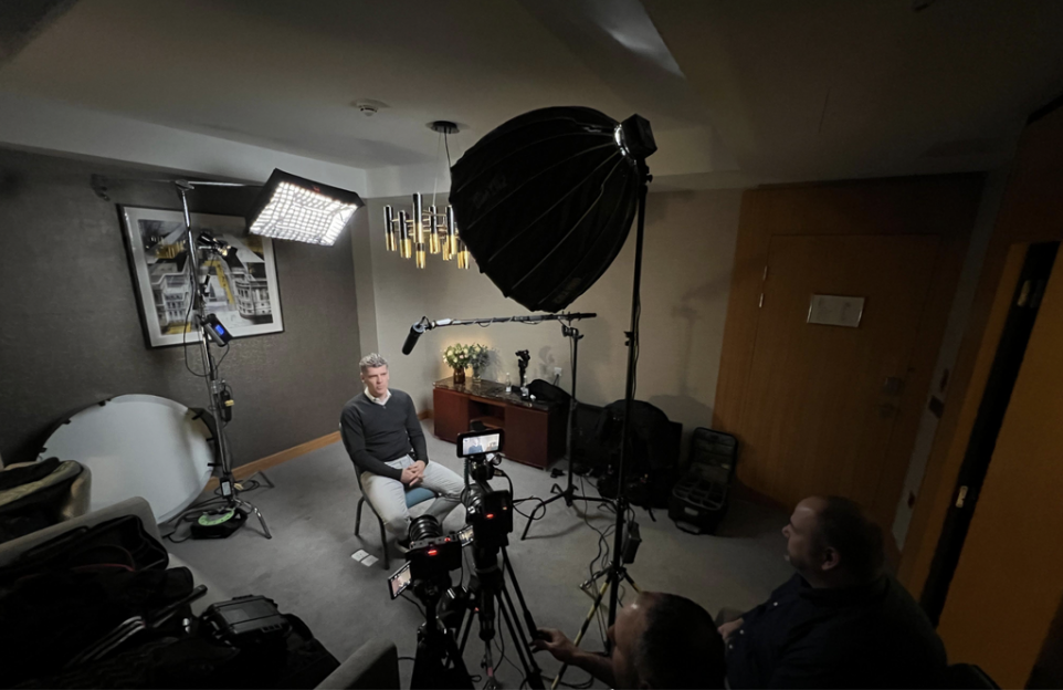 Male being interviewed by a video production agency in a corporate setting.