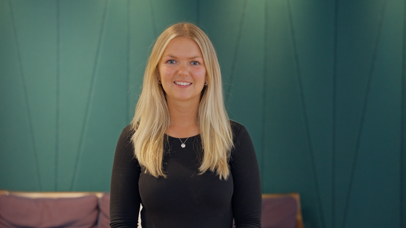 Senior female leader from Evelyn Partners smiling during a recruitment video production shoot focused on women in finance and leadership storytelling