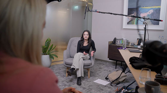 Behind the scenes of a recruitment video production for S&W early careers program, showing a graduate being interviewed in a professional office setup