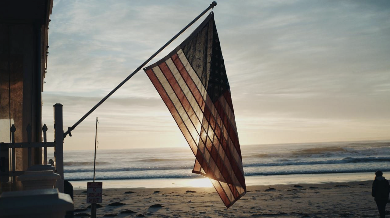 American flag hanging outside a hotel overlooking the beach in Maine