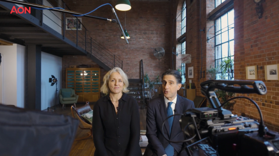 Senior AON executives speaking on camera during a leadership communications video shoot with professional filming equipment