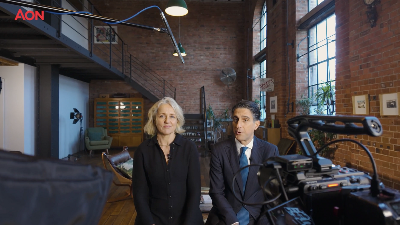 Two AON leaders being filmed on camera in a professional corporate video production setup