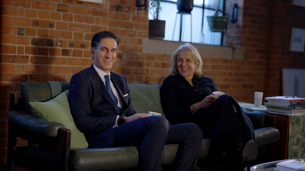 Two senior leaders seated on a sofa during a corporate leadership video shoot in East London